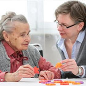 Staff doing a puzzle with a resident