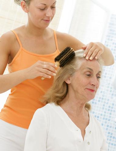 Daughter brushing her mom's hair